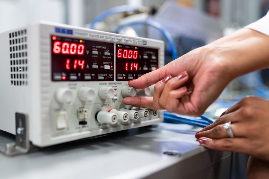 scientist adjusting dials on lab equipment