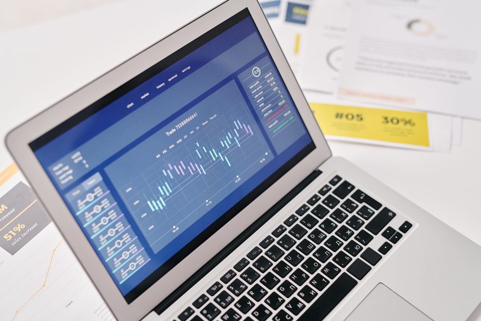 laptop screen with text document and charts