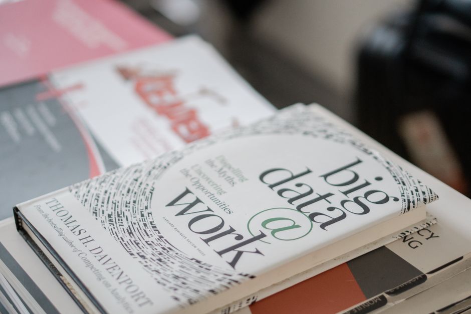 stack of technical books on desk