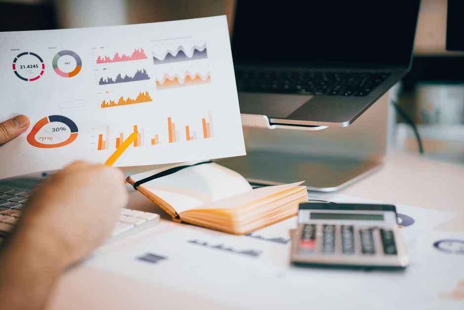 laptop showing data charts on desk