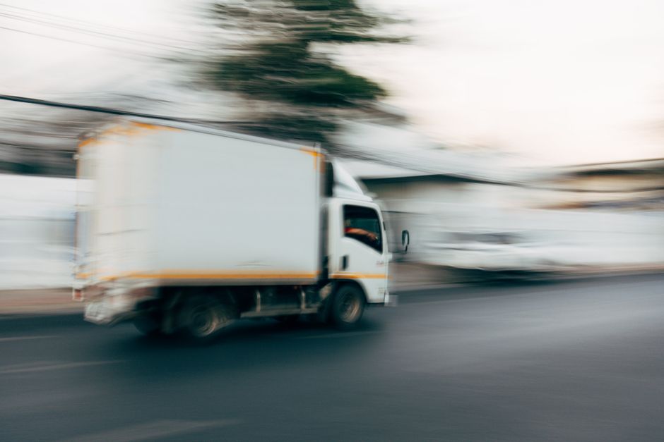 delivery truck driving city street