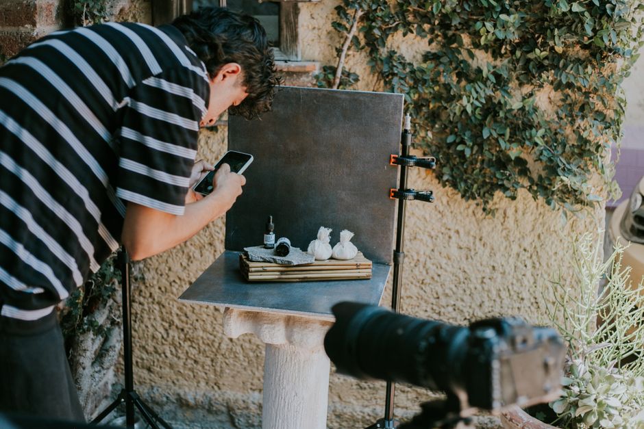 person photographing plants with phone