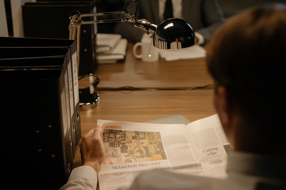 person reading long document at desk