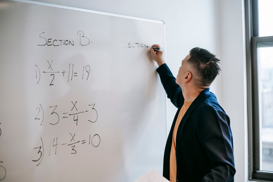 classroom whiteboard with algebra equations