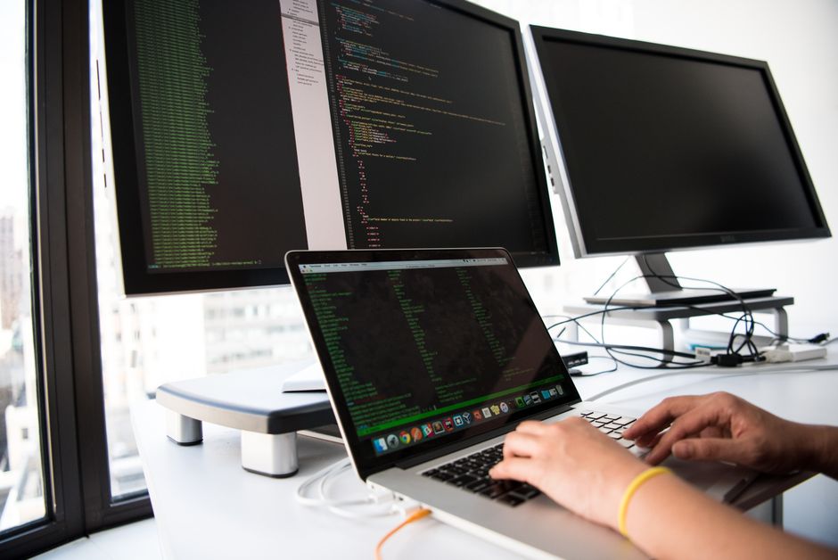 engineer at desk with multiple monitors