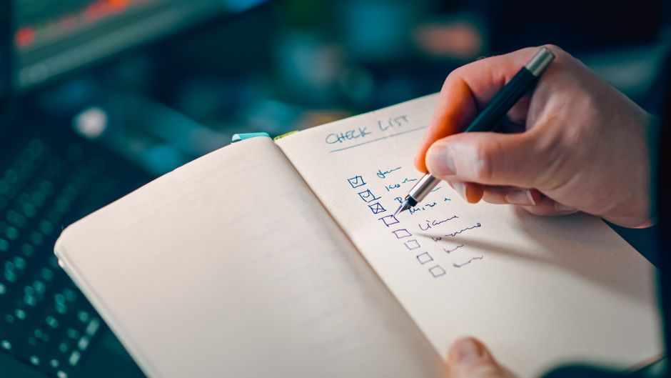 open notebook with handwritten checklist