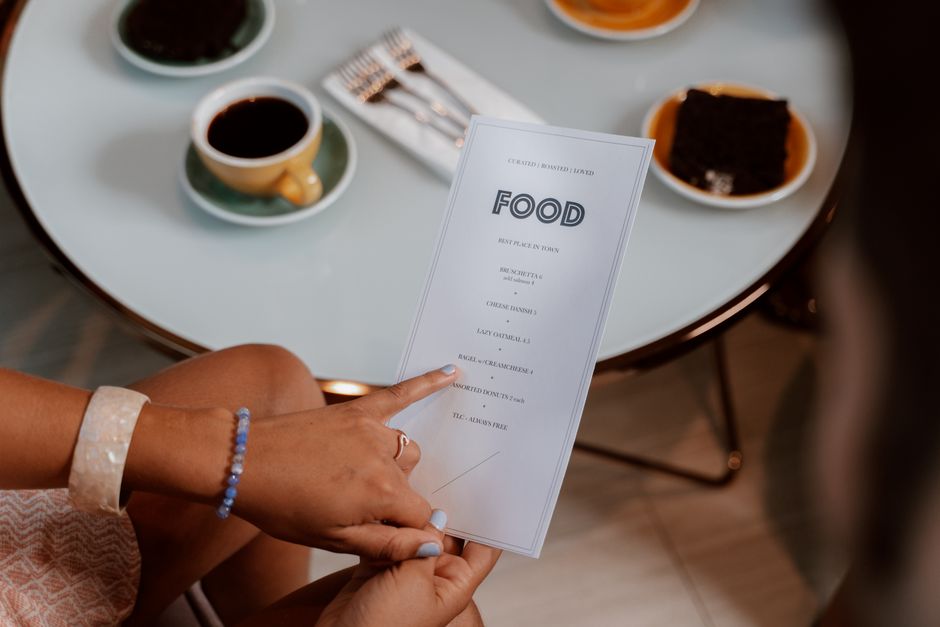 person choosing between restaurant menus