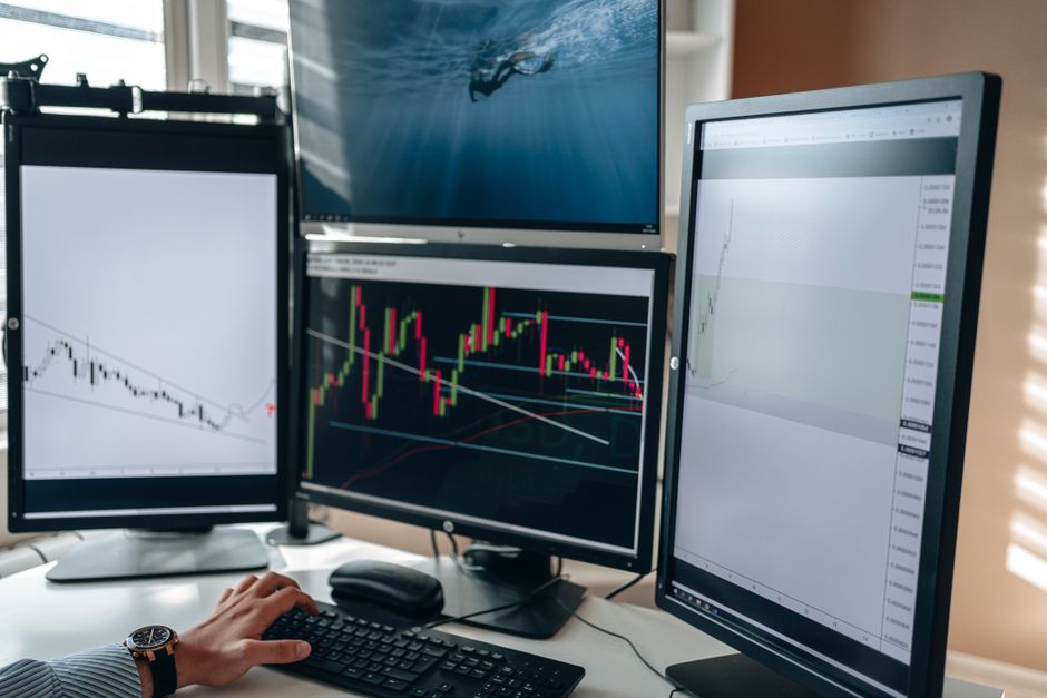 two monitors side by side comparing graphs