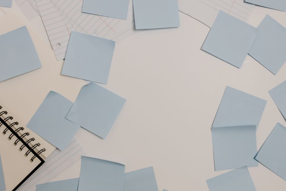 sticky notes sorted into categories on desk