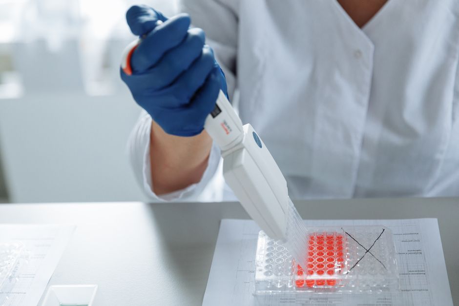 scientist pipetting cell samples