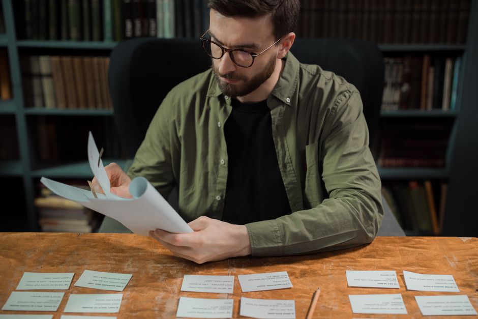 researcher reading paper at desk