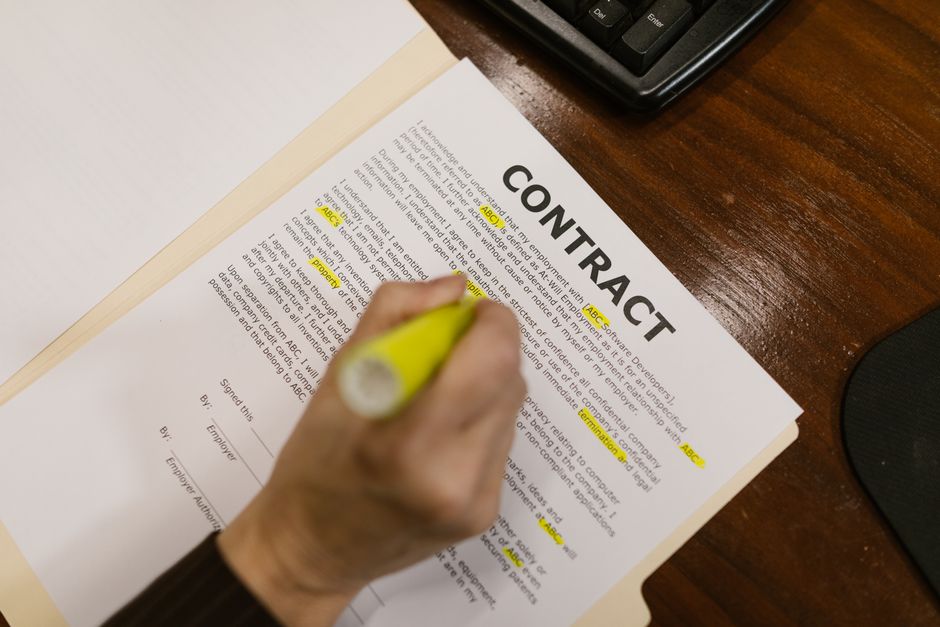 hand highlighting text on paper document