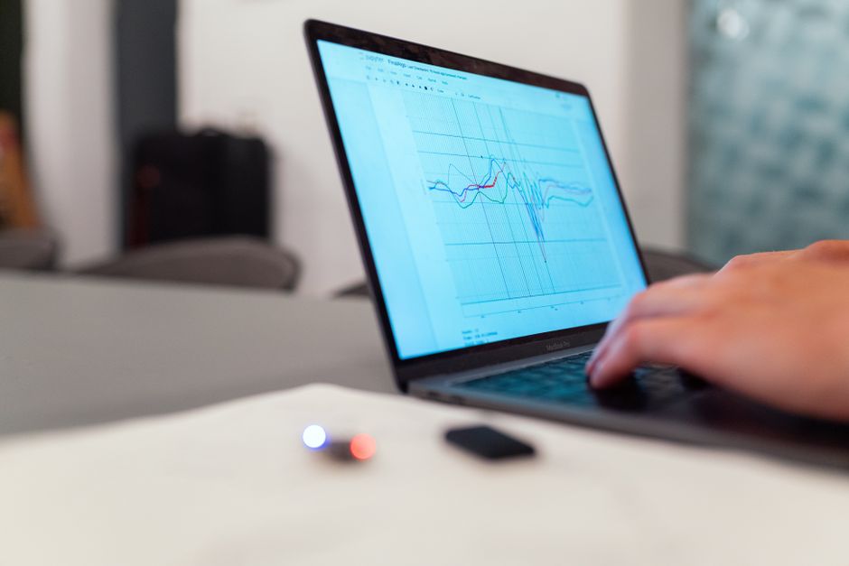 researcher analyzing data charts on laptop