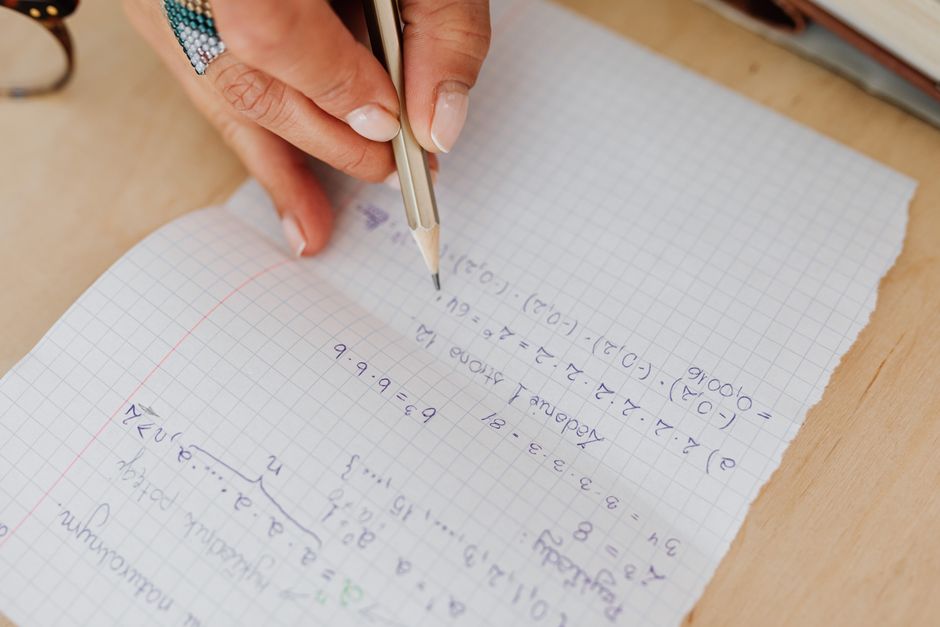 notebook with handwritten equations