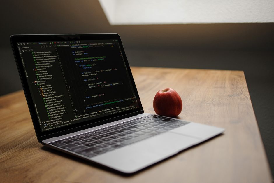 laptop with code editor open on desk