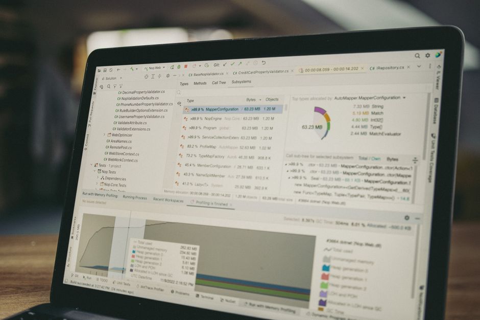 laptop showing data charts and code