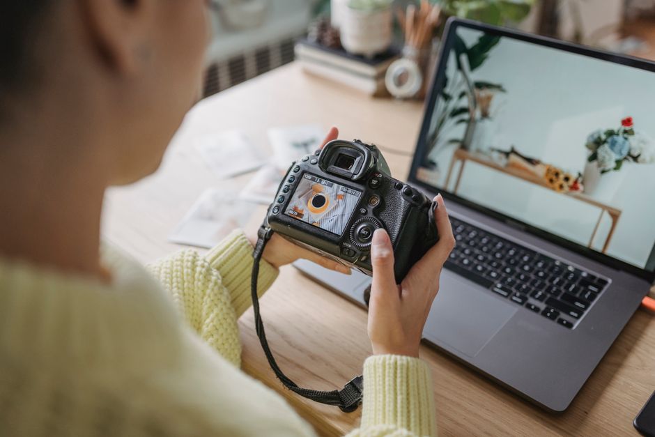 photographer reviewing photos on laptop