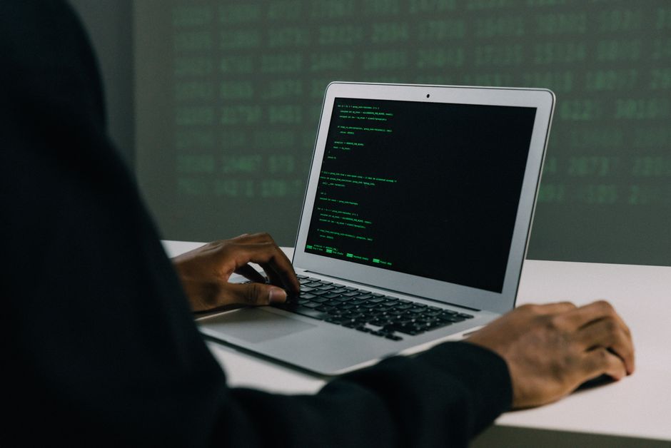 laptop screen showing code and numbers