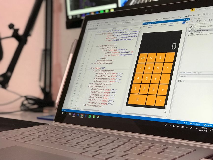 laptop with code and terminal windows