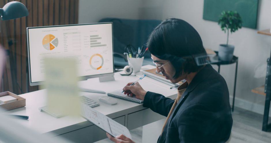 person reviewing data on laptop at desk